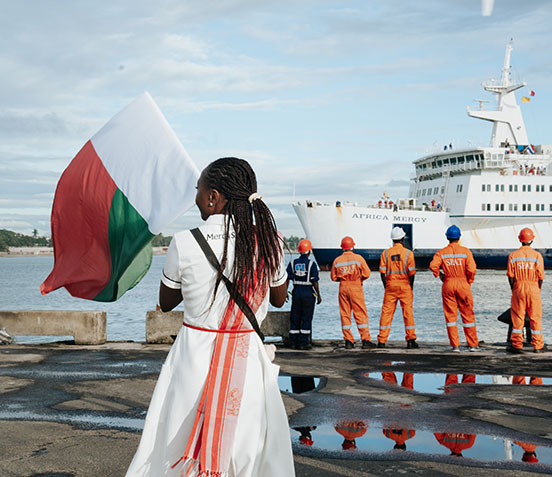 Frau mit Fahne vor Africa Mercy